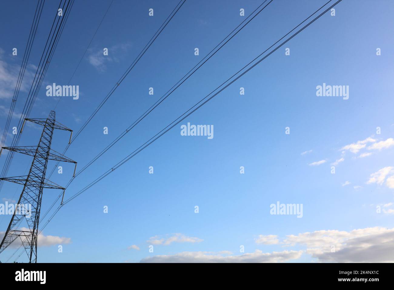 Electricity pylon against deep blue sky with space for copy Stock Photo