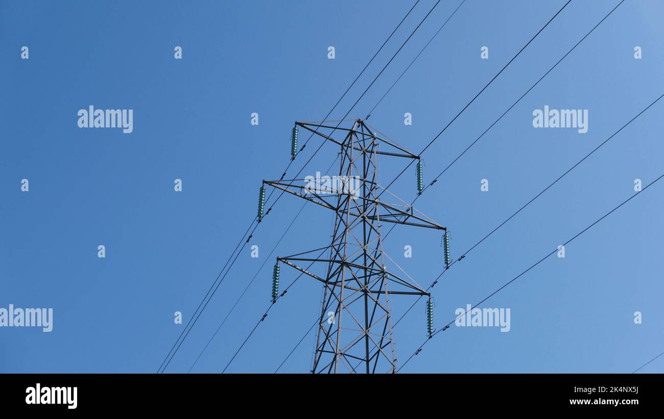 Electricity pylon against deep blue sky with space for copy Stock Photo