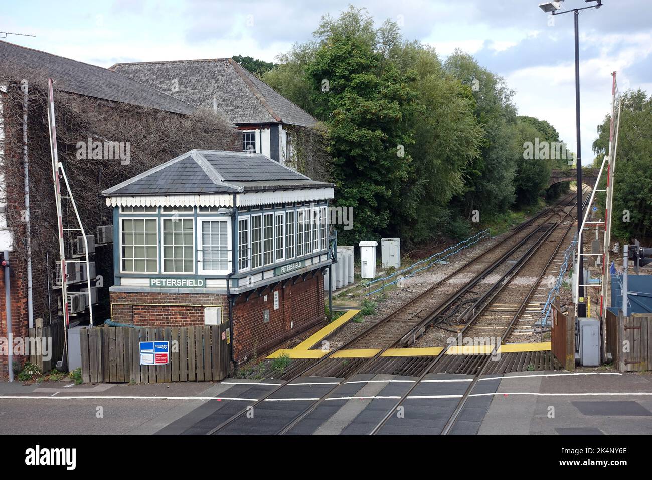 View of the signal box and level crossing at Petersfield railway station in Hampshire UK Stock Photo