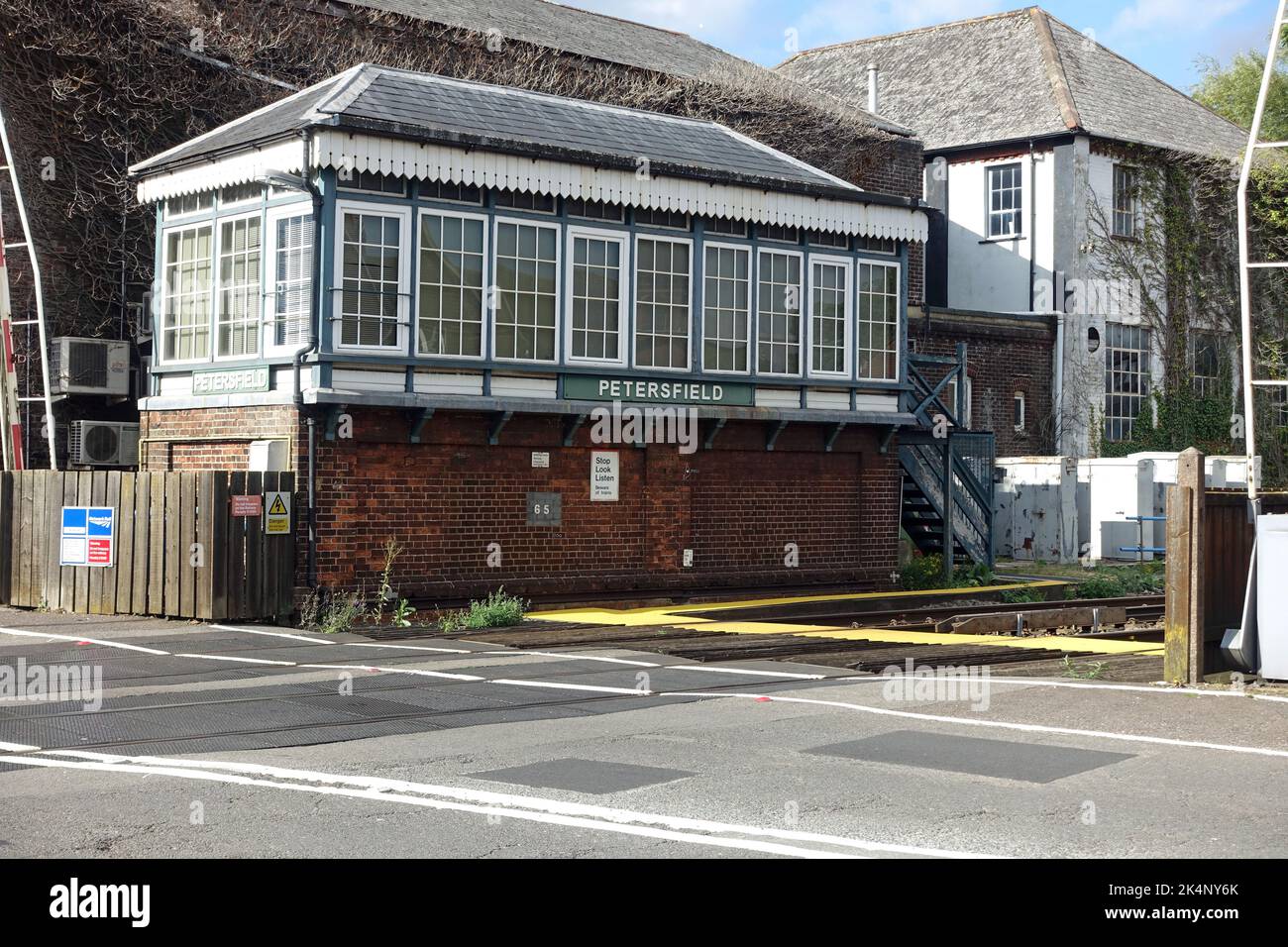 View of the signal box and level crossing at Petersfield railway station in Hampshire UK Stock Photo