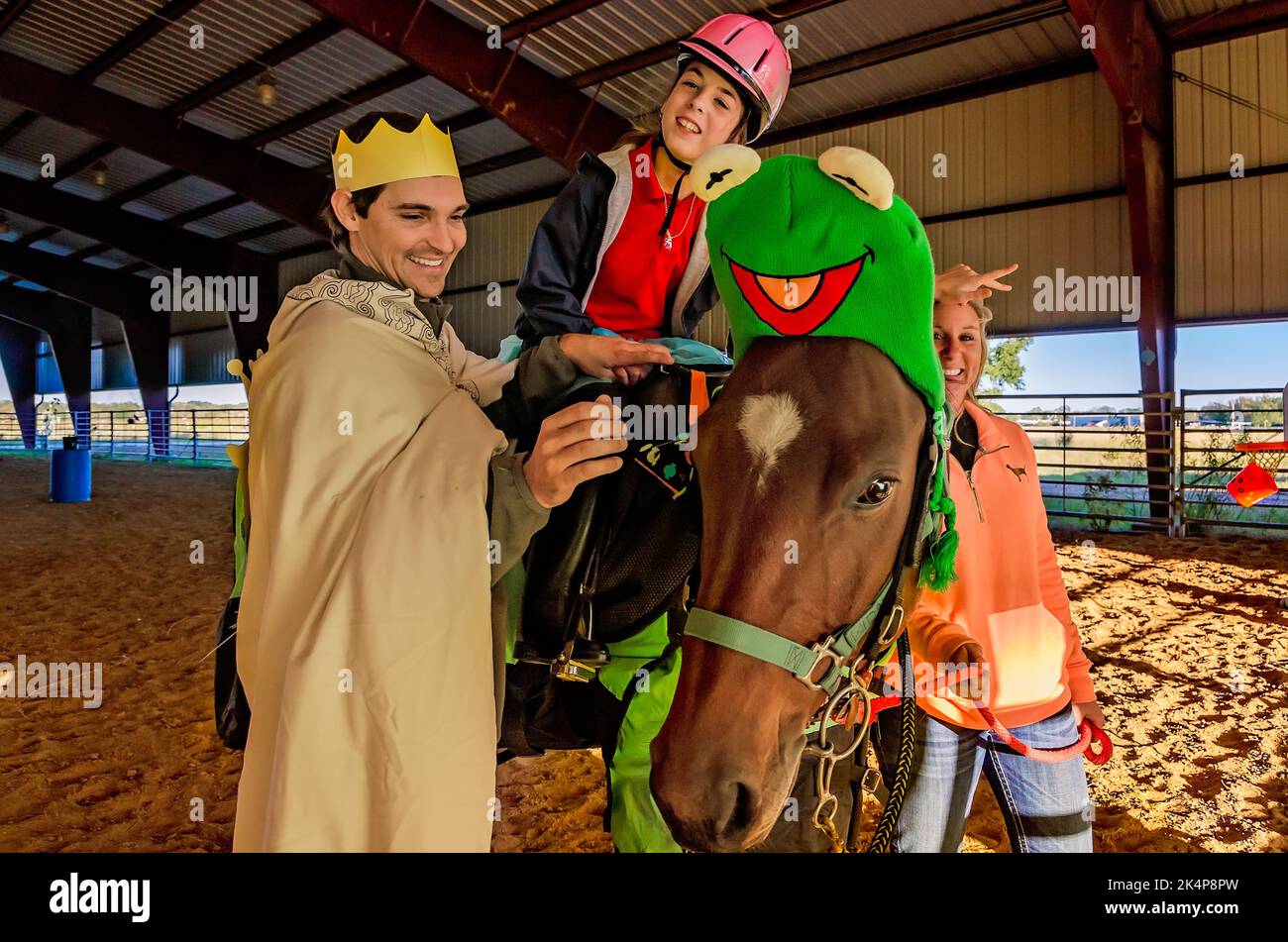 A girl rides a therapy horse at a Halloween costume party for riders in the Therapeutic Equestrian program, Oct. 29, 2012, in West Point, Mississipp Stock Photo
