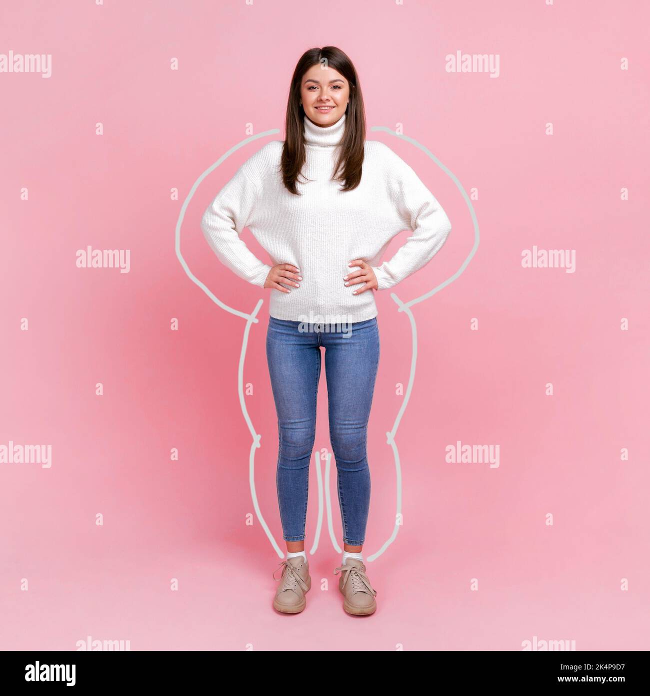 Body care, slimming and workout. Full length portrait of woman drown around, enjoying result of weight loss, standing with hands on hips. Indoor studio shot isolated on pink background. Stock Photo