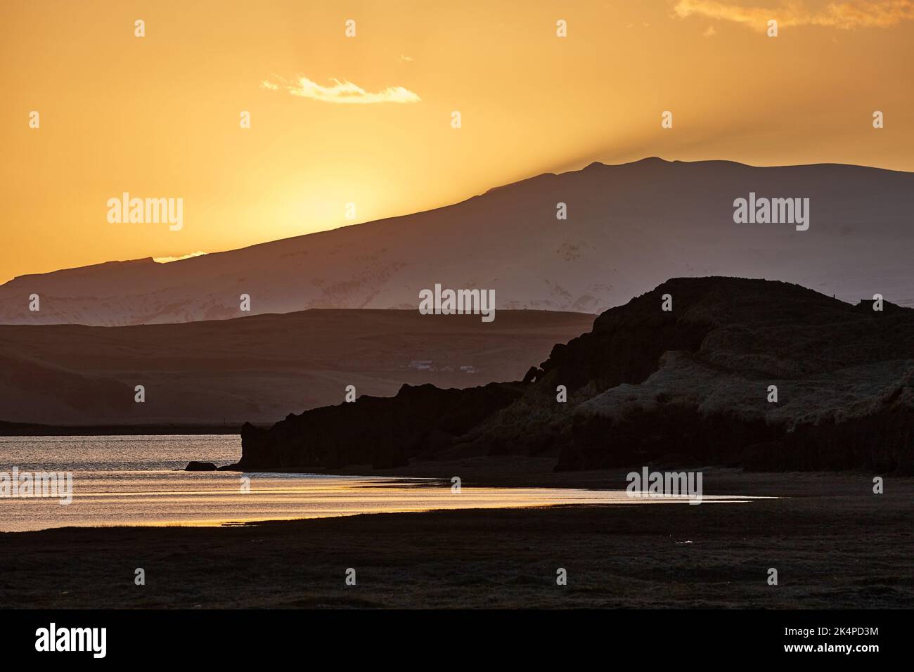 Sunset with Lake and Hilly Landscape Stock Photo