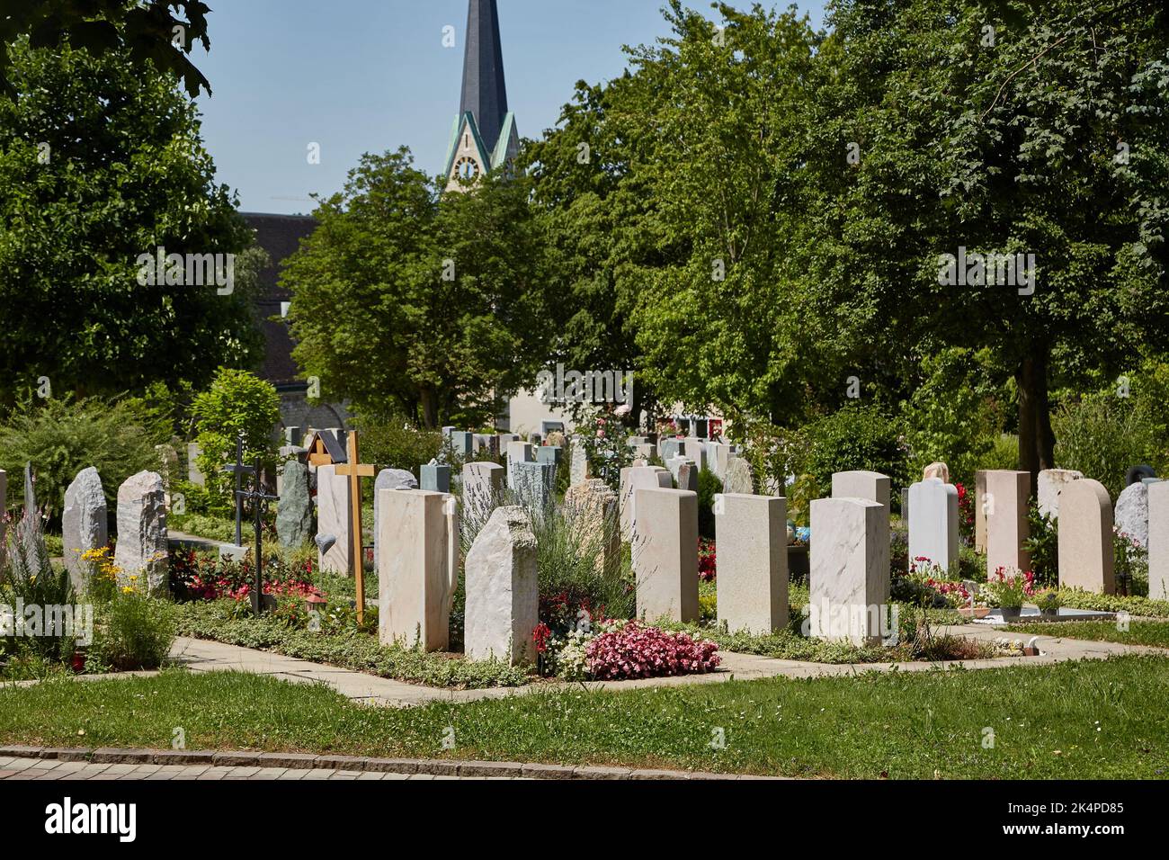 Graveyard with tombstones by a church Stock Photo