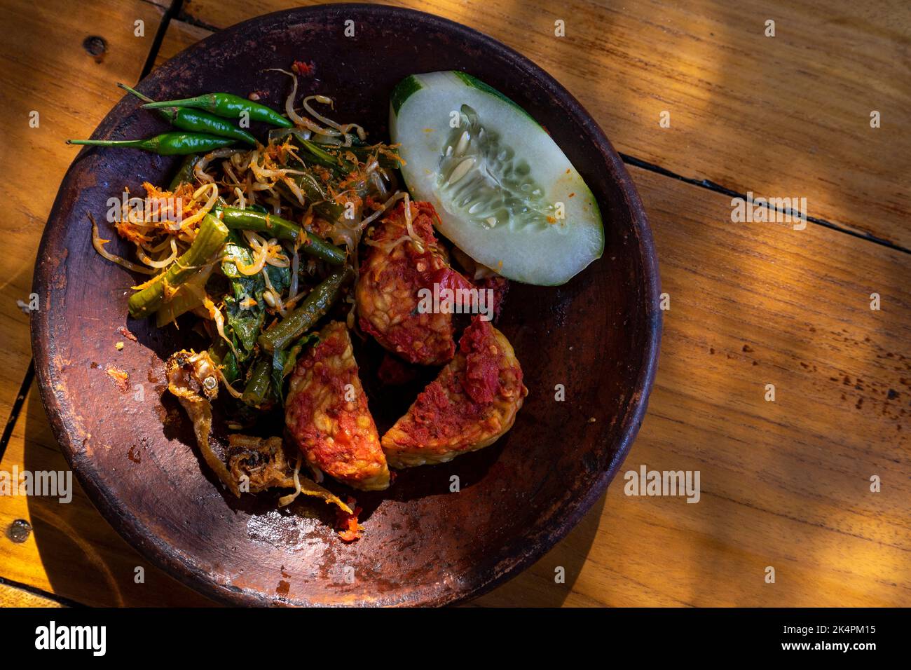 Tempeh Penyet typical Indonesian dish with chili sauce, cucumber and