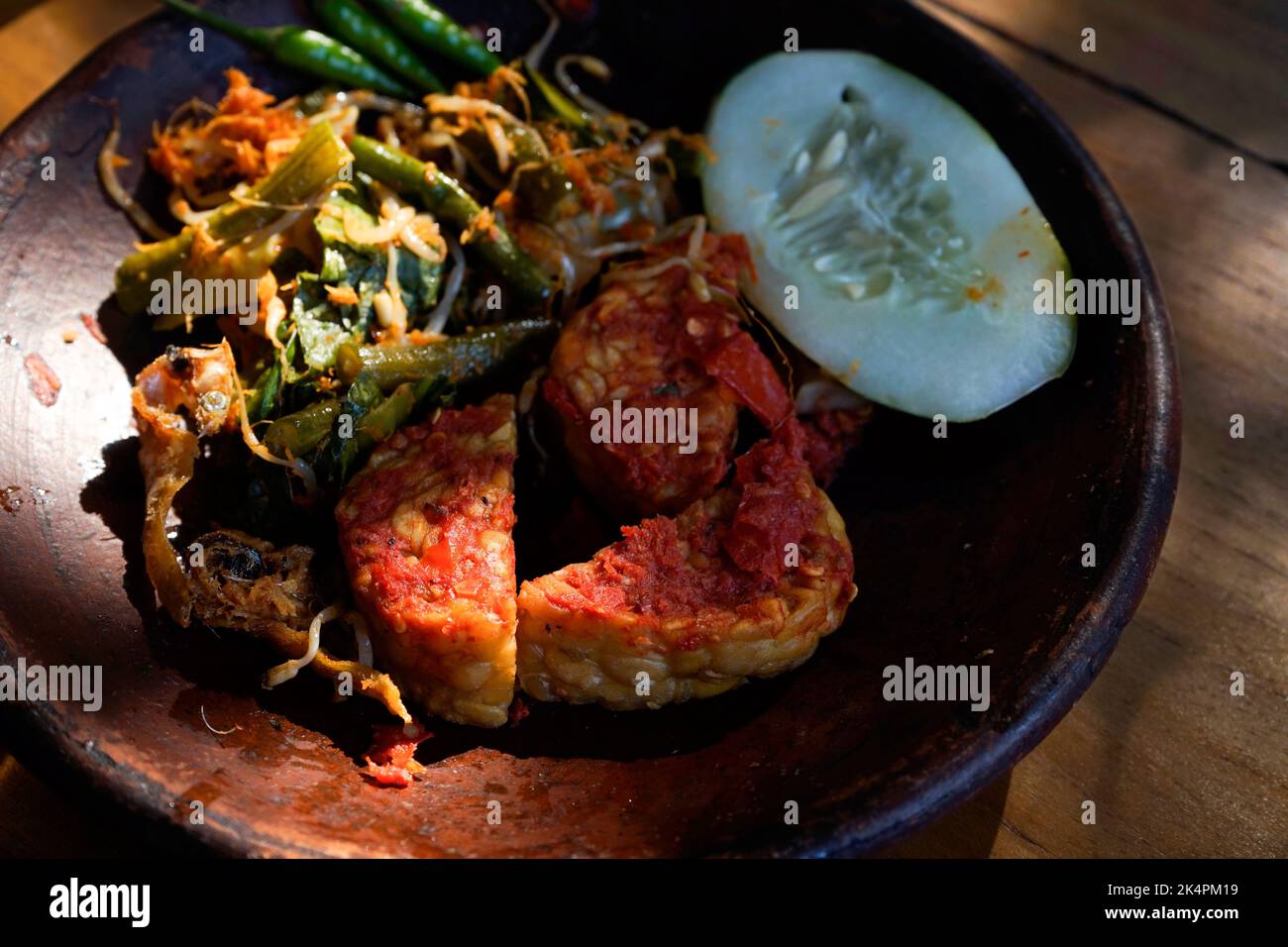 Tempeh Penyet typical Indonesian dish with chili sauce, cucumber and