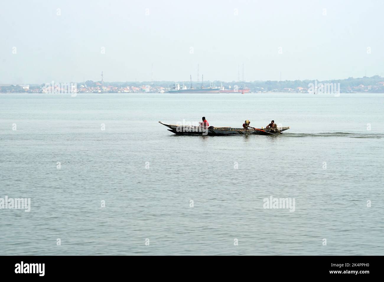 Traditional boat maneuver in Tanjung Perak port, Surabaya, Indonesia on August 2022 Stock Photo