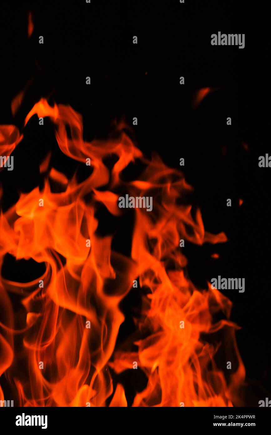 Fire. Flames on a black background. Tongues of flame, sparks . Stock Photo