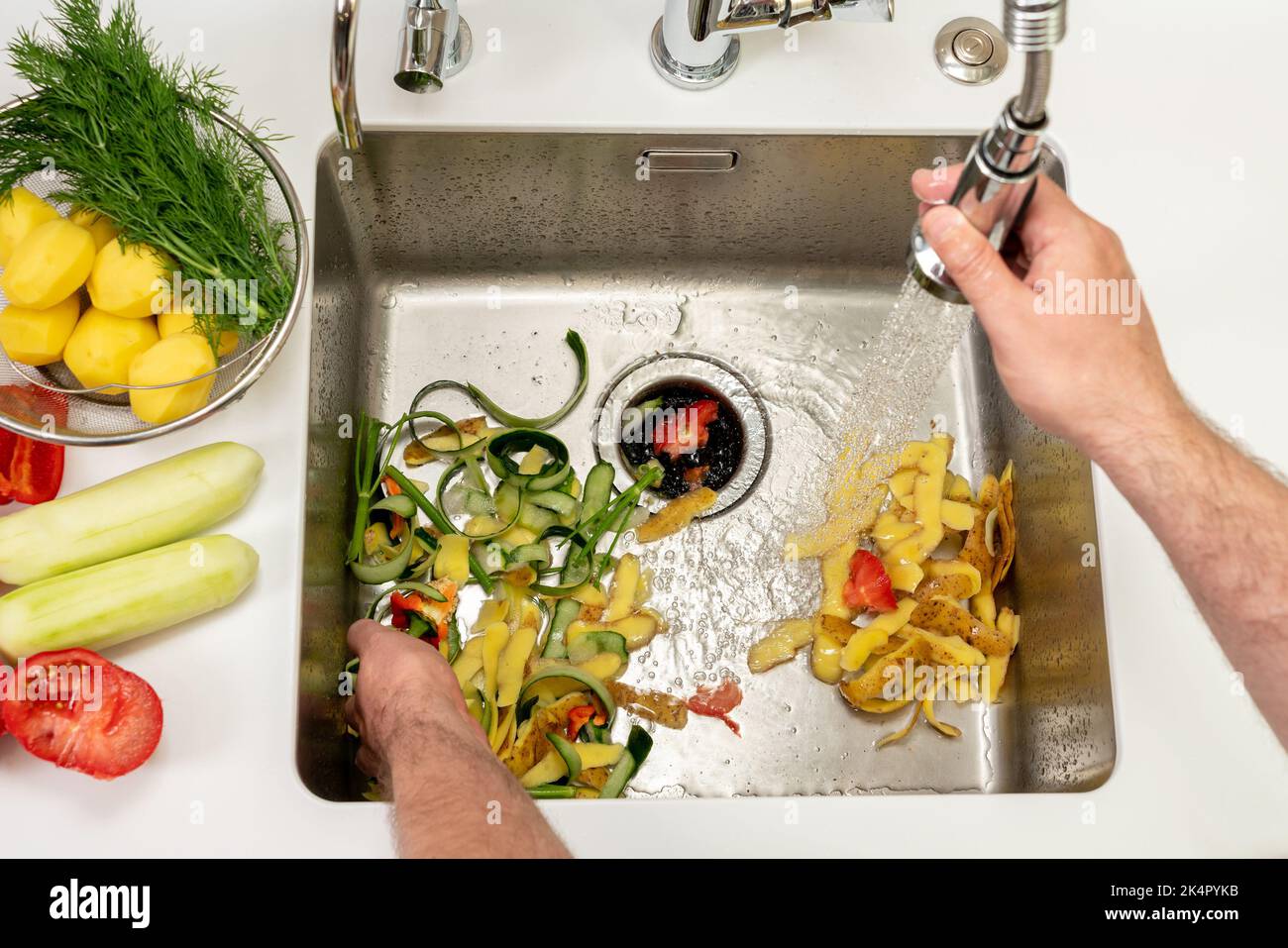 Working kitchen disposer on a modern sink to remove food waste Stock