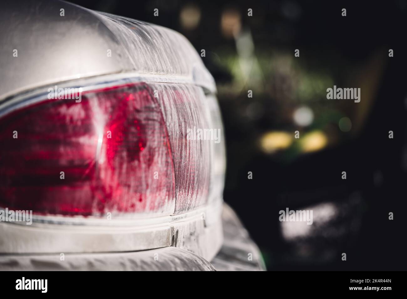 Layer of dust coving the taillight of a car after driving down a gravel