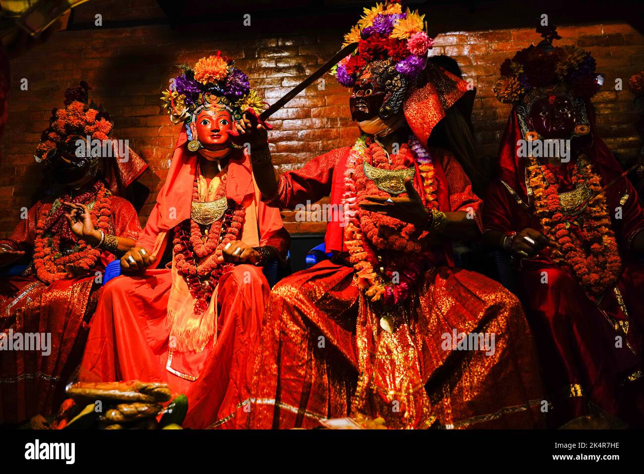 Devotees offer prayers to masked people clad as deities before the ...
