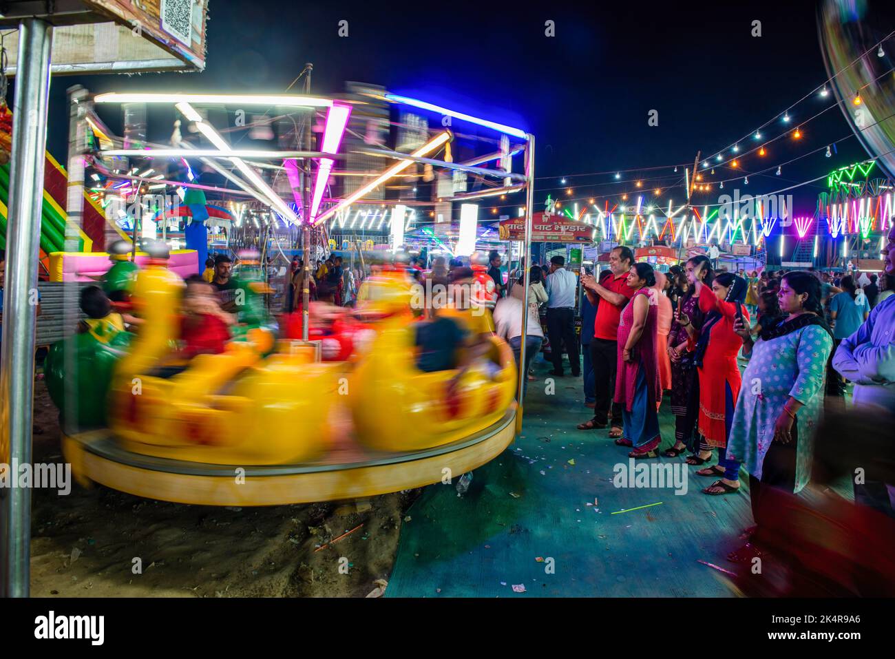 Ghaziabad, India. 03rd Oct, 2022. People seen on swings during a Ramlila event held in Ghaziabad. A ten-day carnival during Ramlila is a dramatic folk re-enactment of the life of the Hindu god Rama. (Photo by Pradeep Gaur/SOPA images/Sipa USA) Credit: Sipa USA/Alamy Live News Stock Photo
