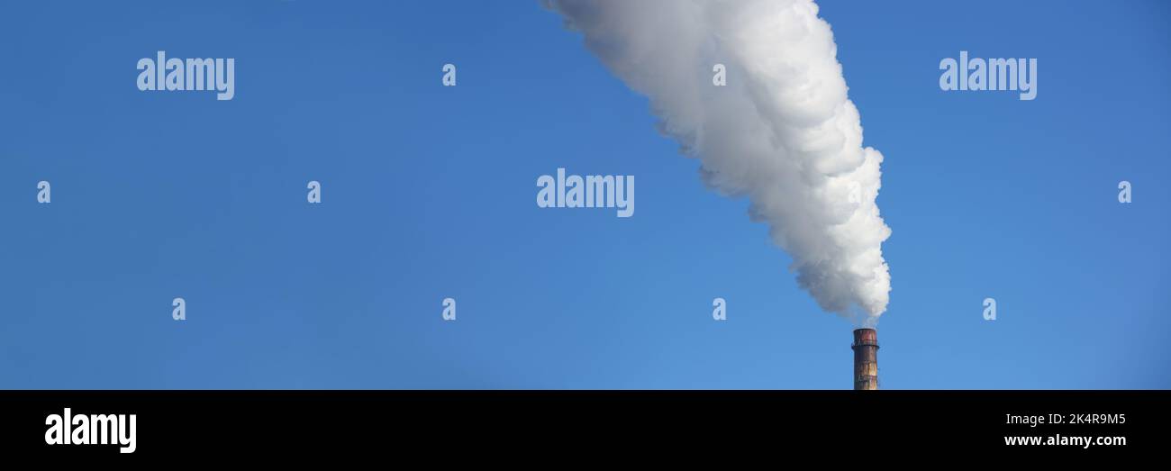 Chimney blows white smoke into blue sky Stock Photo - Alamy