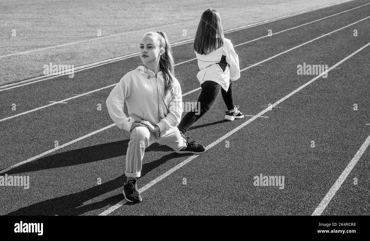 Physical training for children. Fit girls do outward lunging. Physical