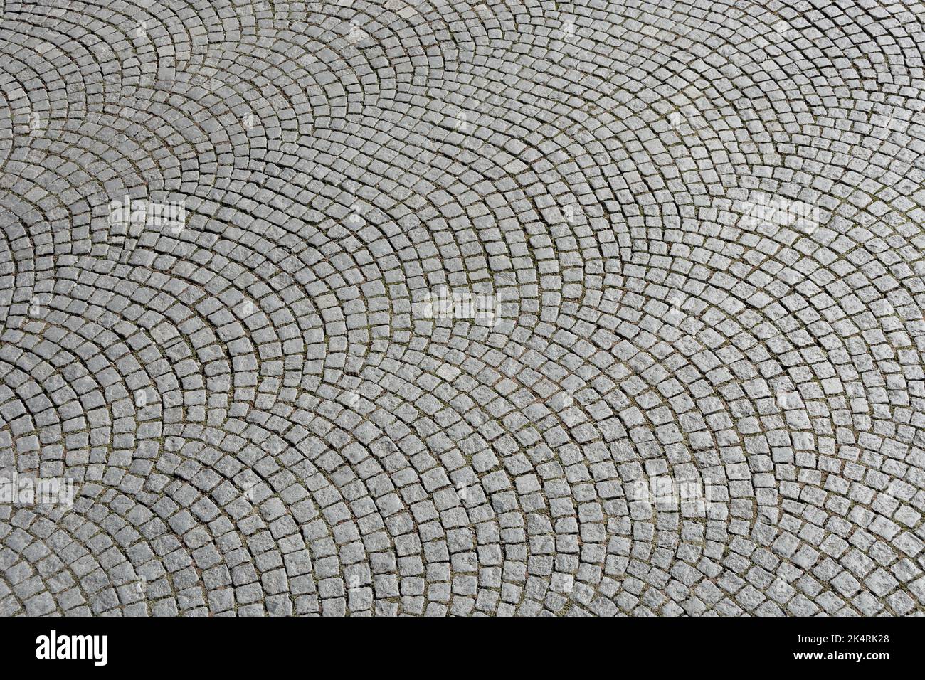 Natural stone paving laid in segment arches Stock Photo