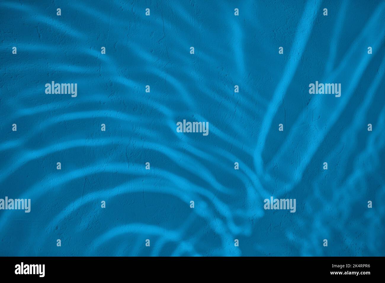 Shadow and light water caustic effect on blue concrete wall Stock Photo