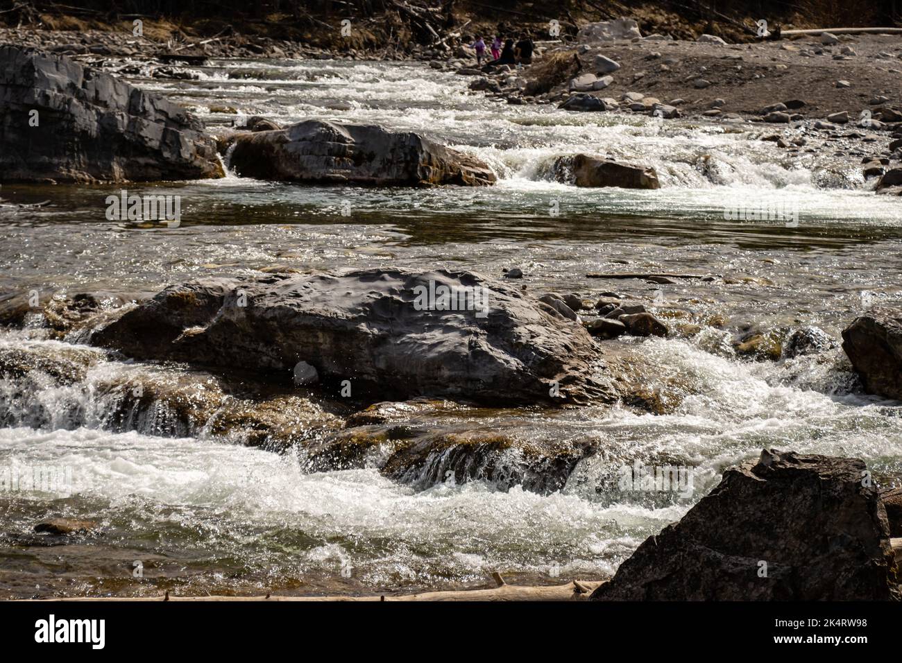 A river flowing in a rocky area under the sunlight Stock Photo - Alamy