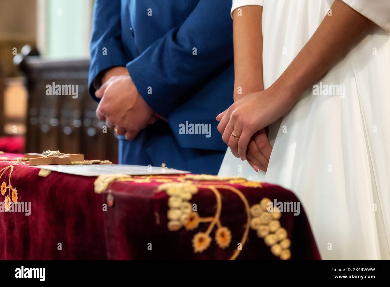 newlyweds in front of the altar in the church. close up view Stock Photo