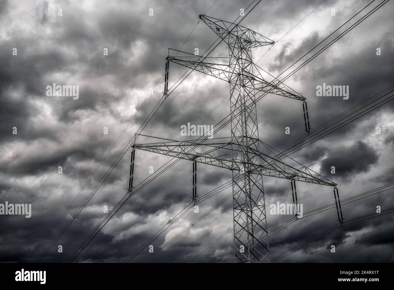 High voltage pole and dark clouds on sky. Stock Photo