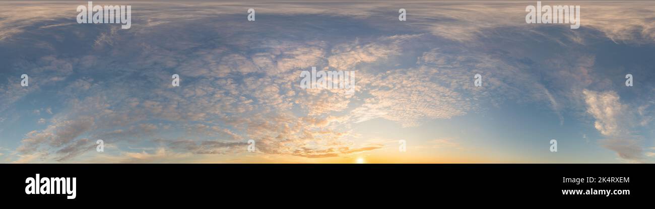 Dark blue sunset sky panorama with golden Cirrus clouds. Seamless hdr 360 panorama in spherical equirectangular format. Full zenith for 3D Stock Photo