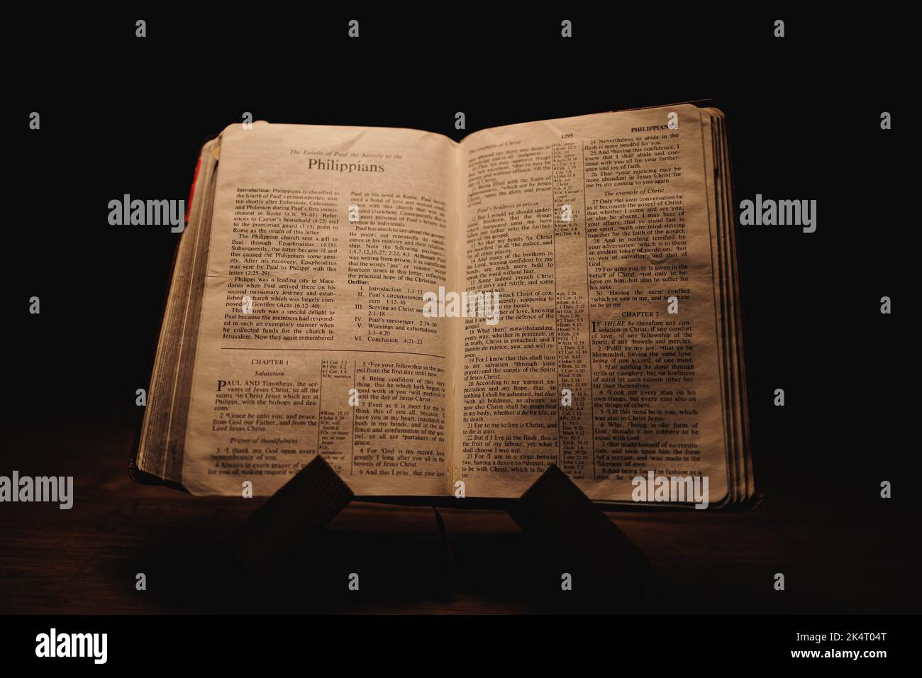 A closeup shot of a historic old Bible open on the Philippians pages on ...