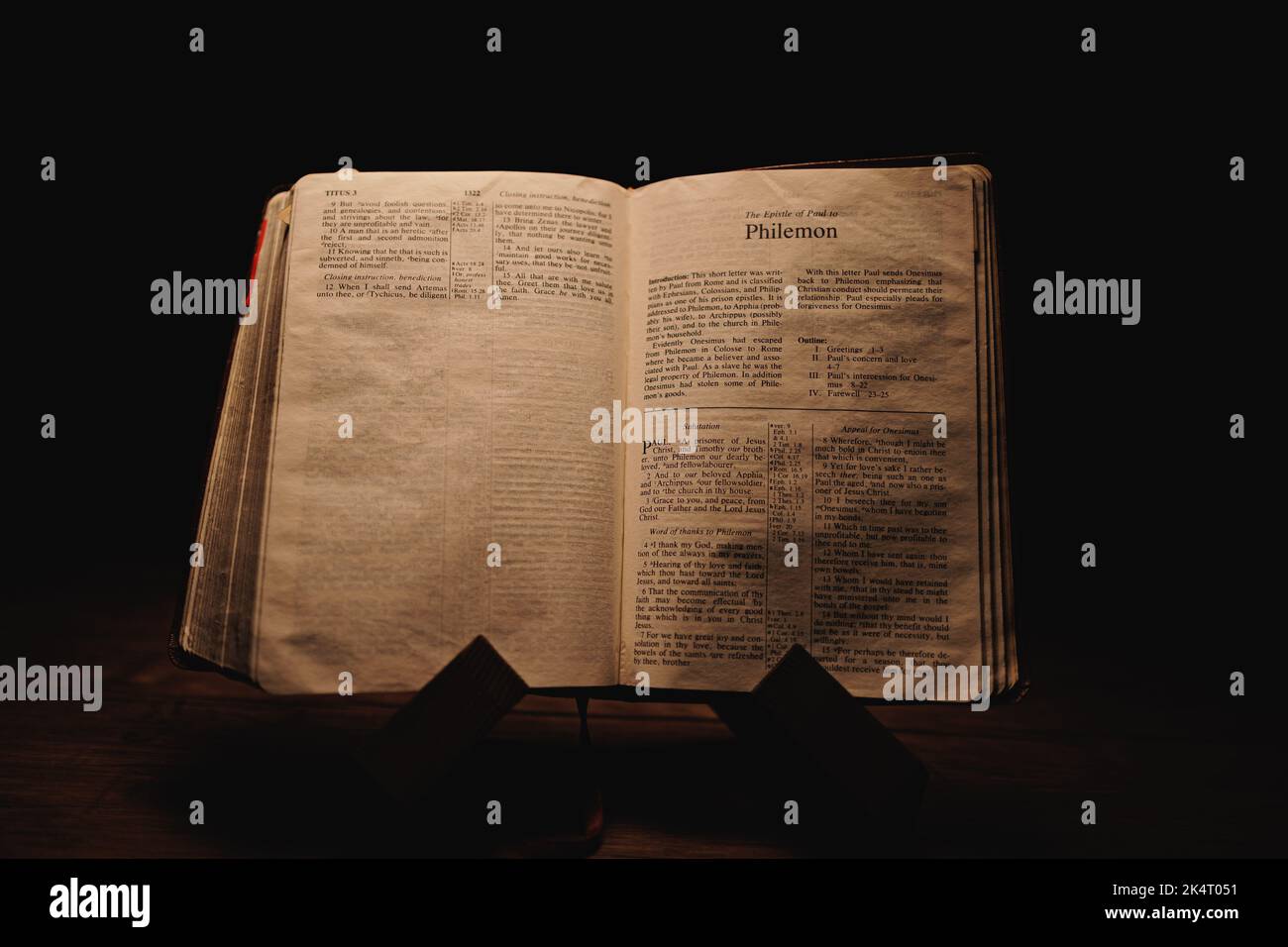 A closeup shot of a historic old Bible open on the Philemon pages on ...