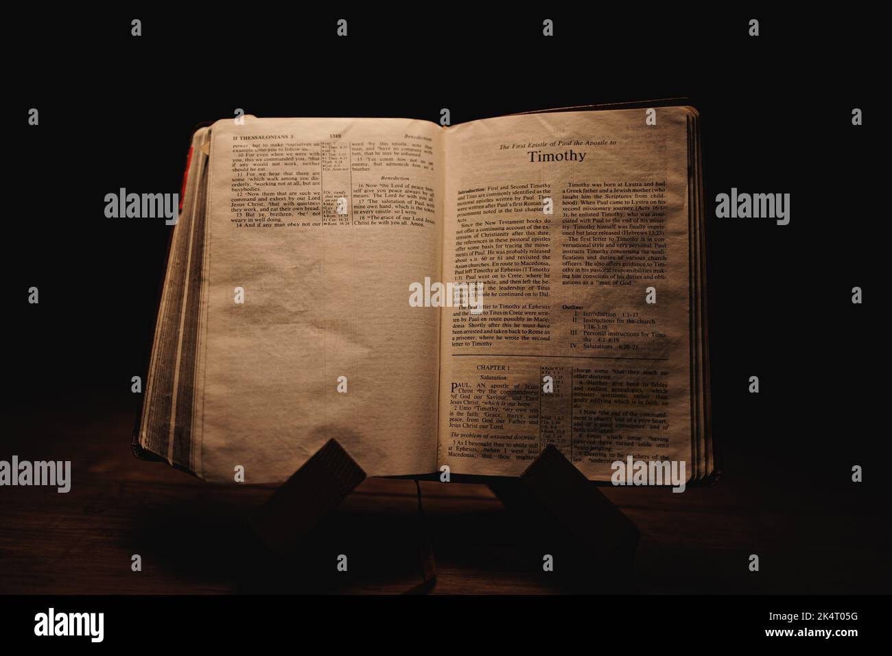A closeup shot of a historic old Bible open on the Timothy pages on ...