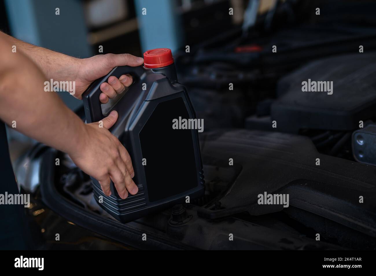 Auto mechanic performing the motor oil change Stock Photo Alamy