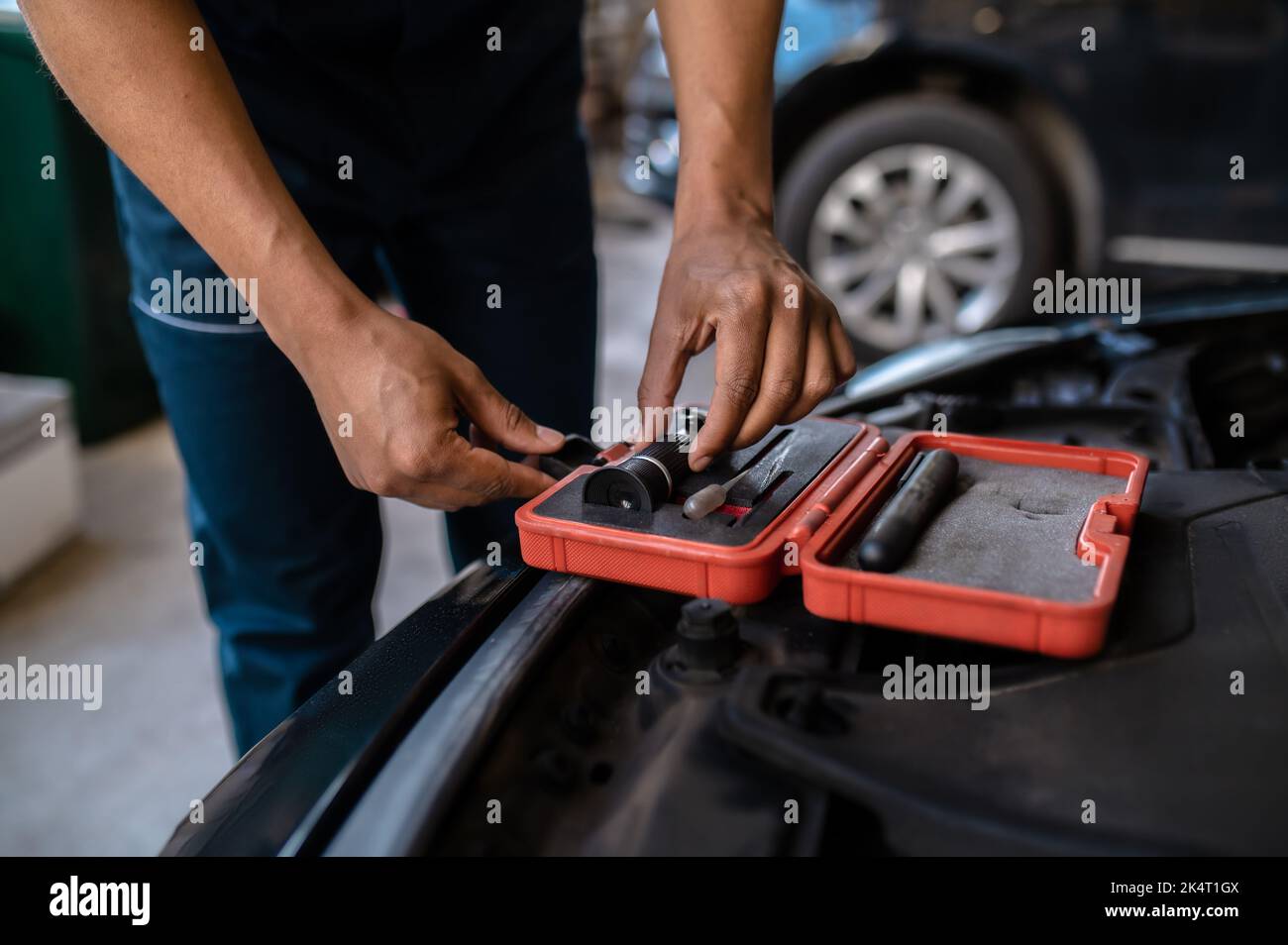 Mechanic selecting an optical tool for work Stock Photo Alamy