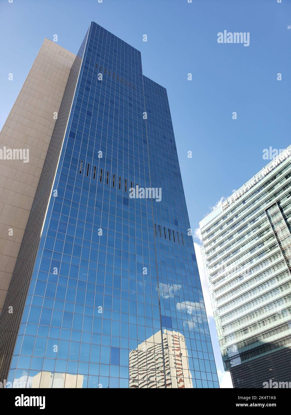 A Vertical Shot Of The Exterior Design Of A Modern Company Building 