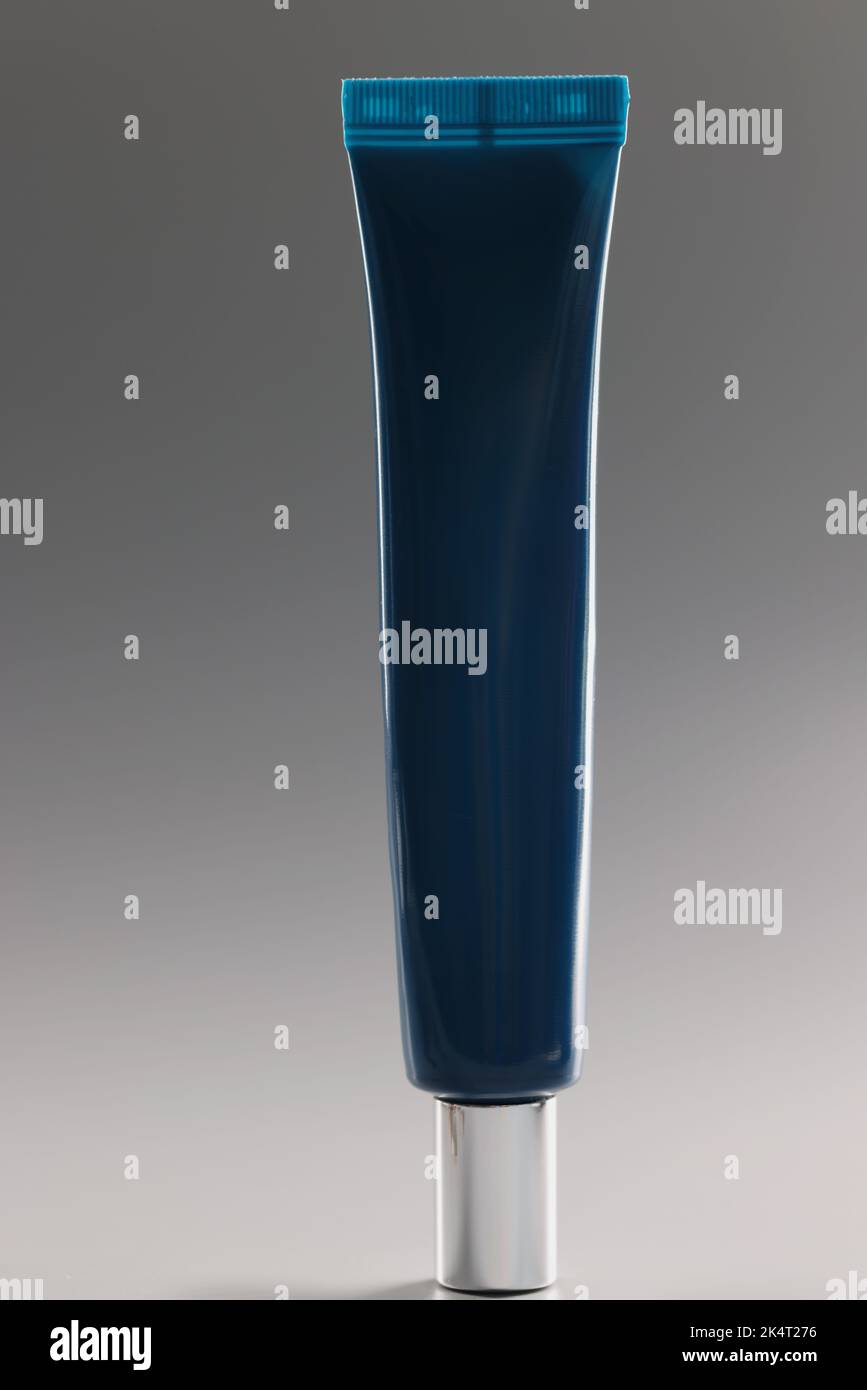 Blue tube with cream on a gray background, makeup Stock Photo
