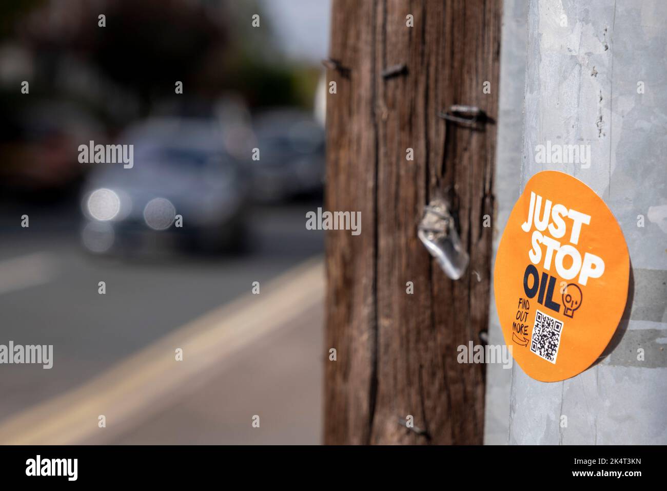 Car passing a Just Stop Oil sticker on a lamp post on 30th August 2022 in Birmingham, United Kingdom. Just Stop Oil is a coalition of groups working together to ensure the Government commits to halting new fossil fuel licensing and production. Stock Photo