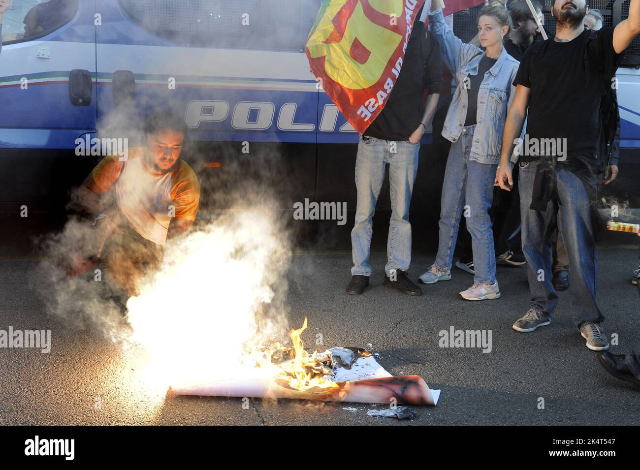 Milan, October 2022, USB base unions protest in front of ENI's city office against rising gas prices due to the international energy crisis and speculation. A facsimile of gas bill is burnt Stock Photo