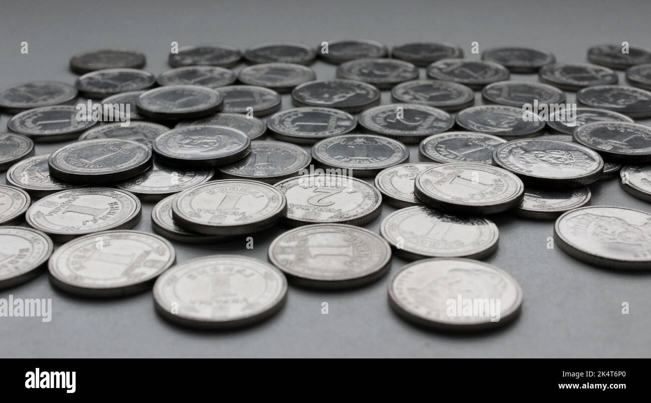 Ukrainian money in nickel coins with ridged edge scattered on a white background closeup Stock Photo