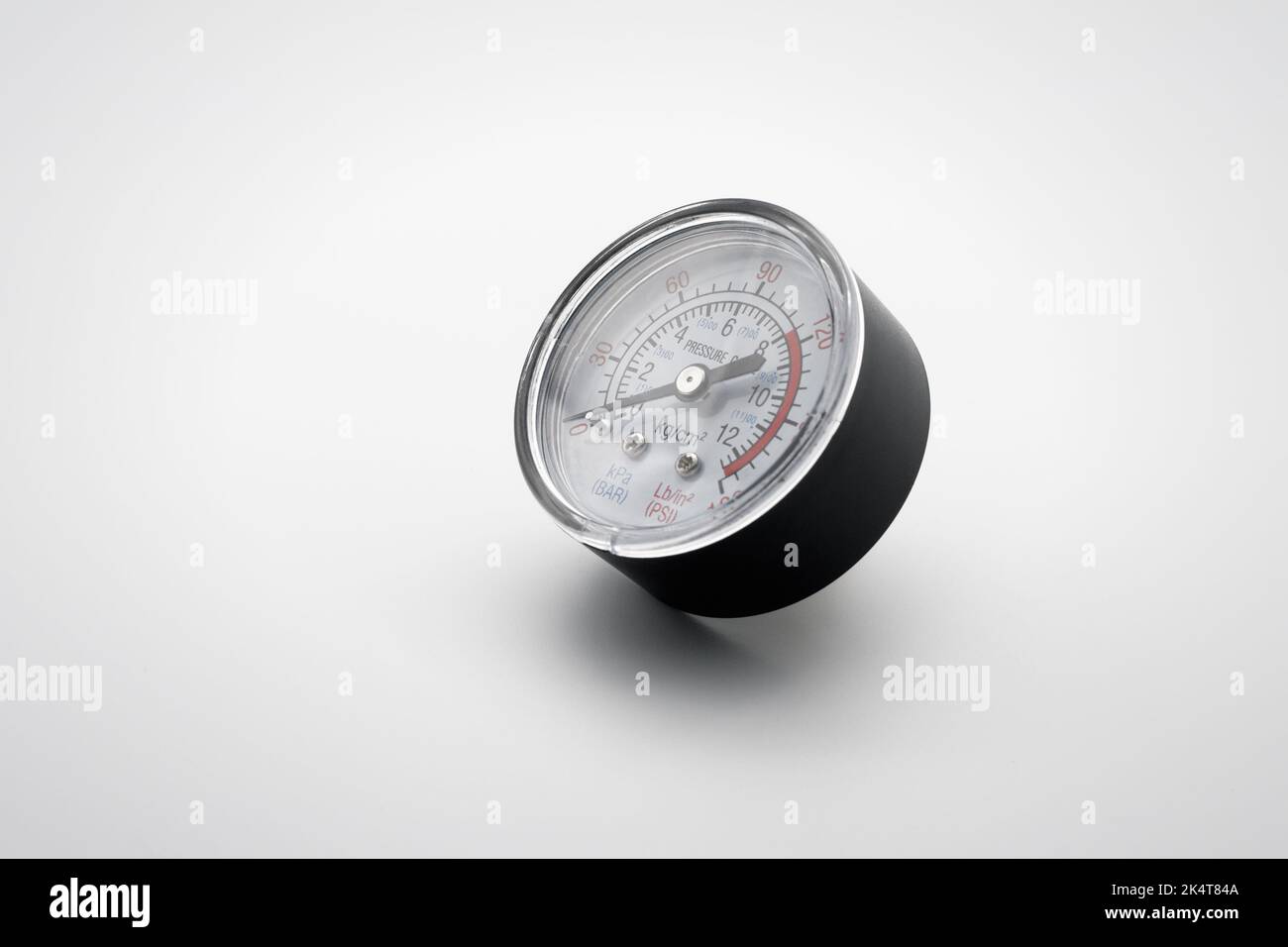 Small pressure gauge. Close-up. On white background. Stock Photo