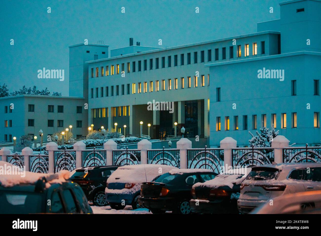 View of building of medical hospital on a winter evening. ars are parked in front of the medical center in winter season Stock Photo