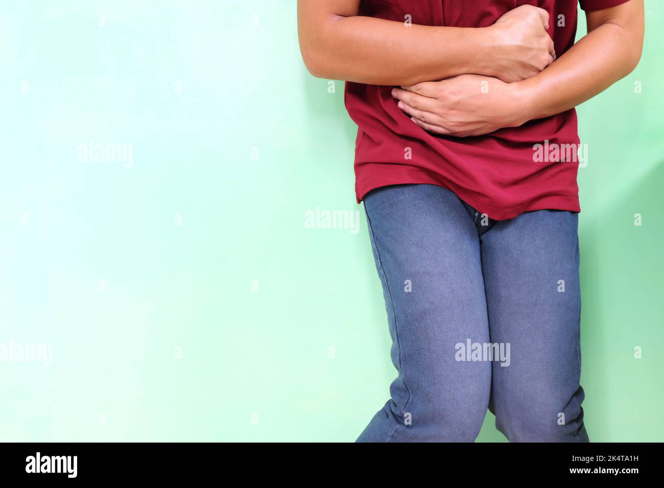 Diarrhea and loose bowel movement concept. Young Asian man holding his