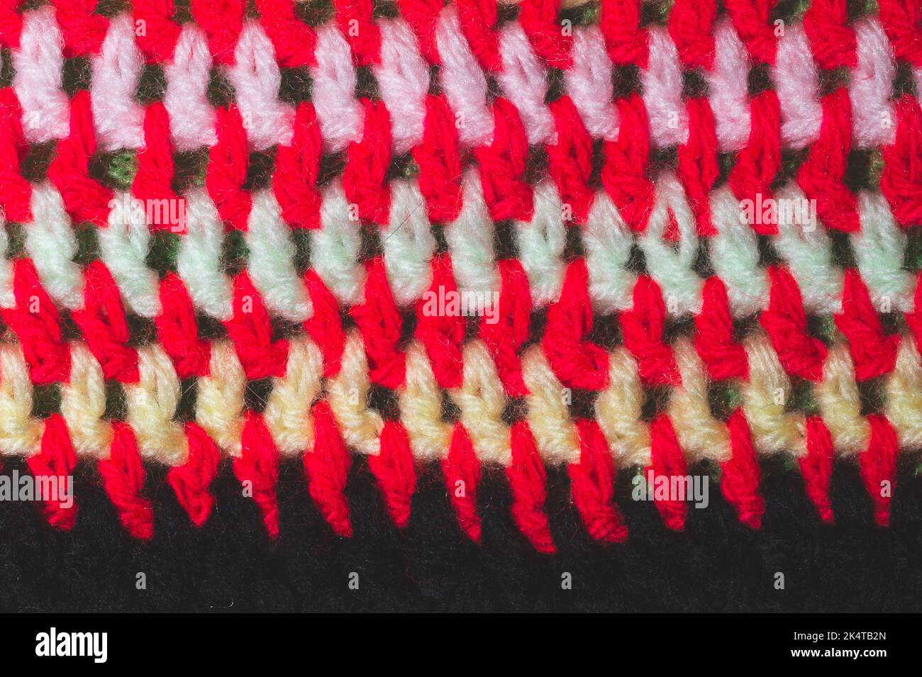 Knitted background from colored threads close up. homemade needlework Stock Photo