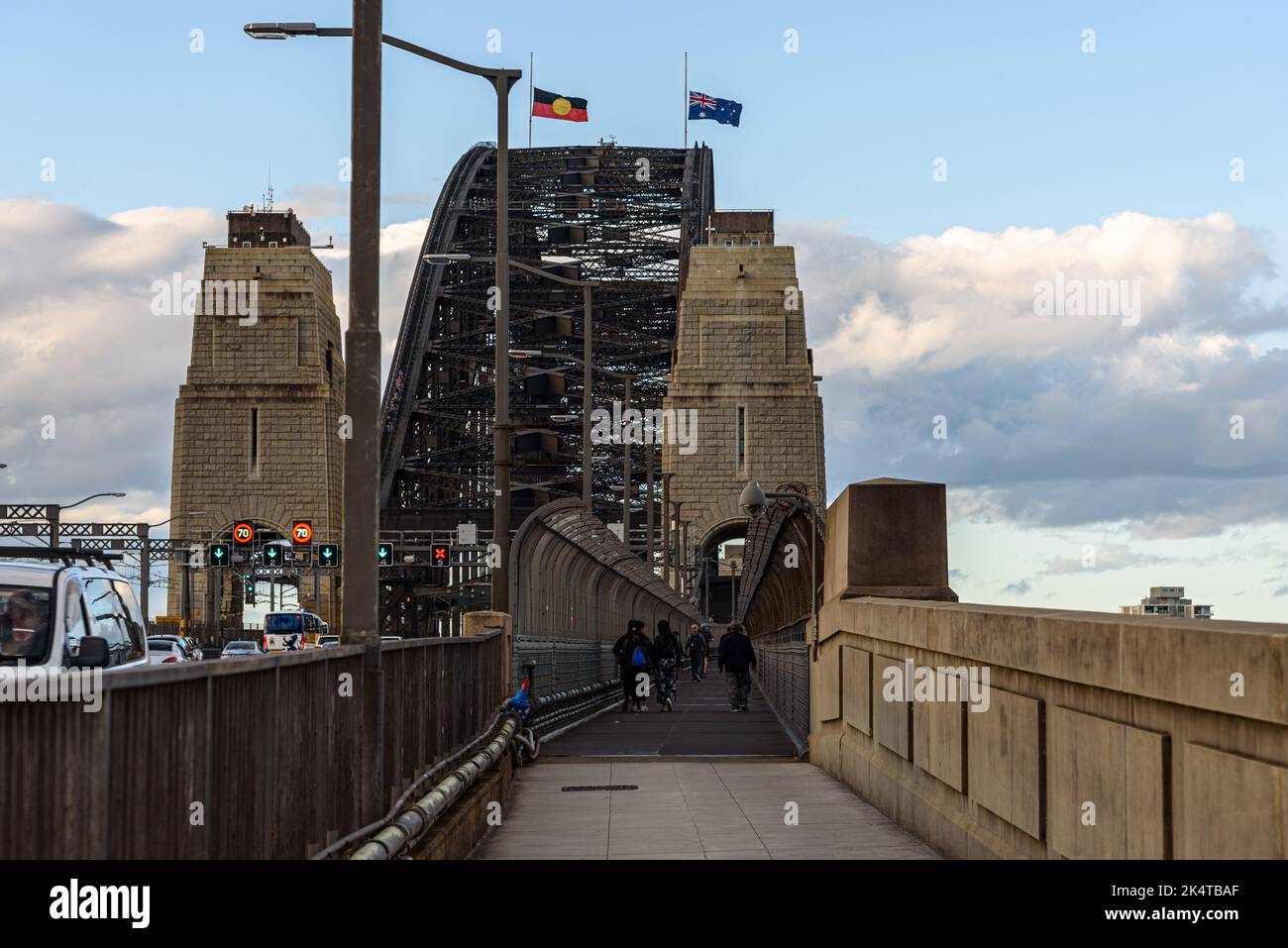 People walking across the Sydney Harbour Bridge on the pedestrian footpath Stock Photo