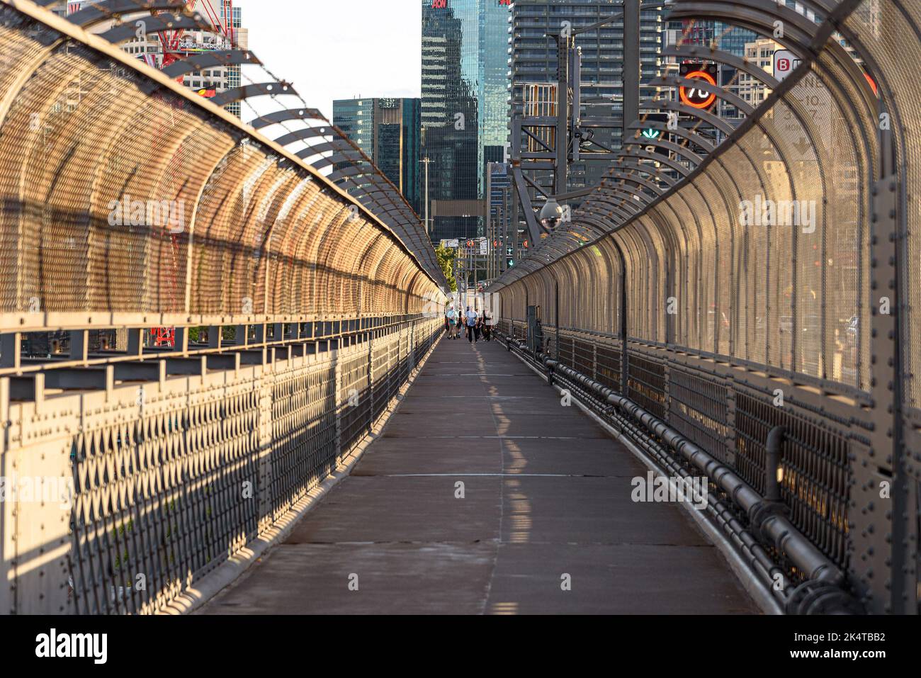 People walking across the Sydney Harbour Bridge on the pedestrian footpath Stock Photo