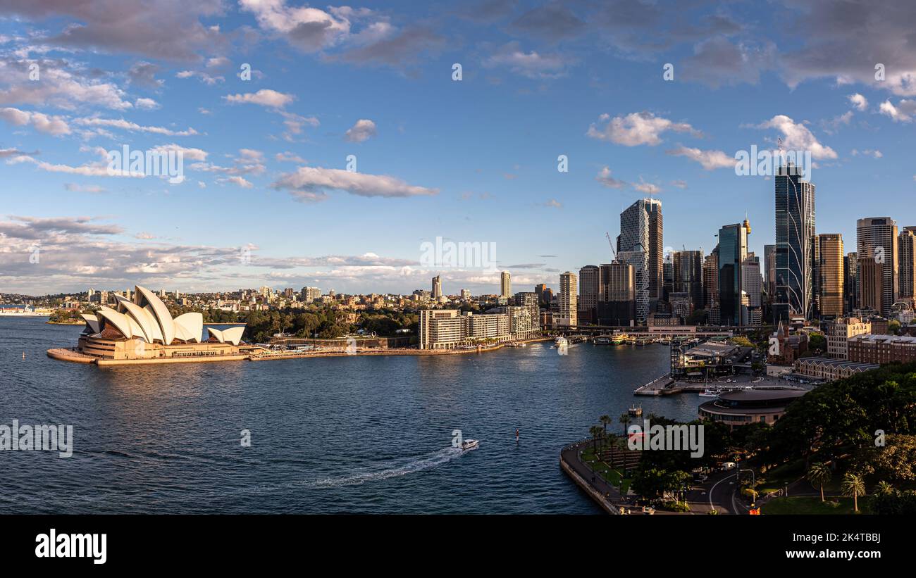 The Sydney Opera House on Bennelong Point with the skyscrapers at Circular Quay on a sunny afternoon Stock Photo