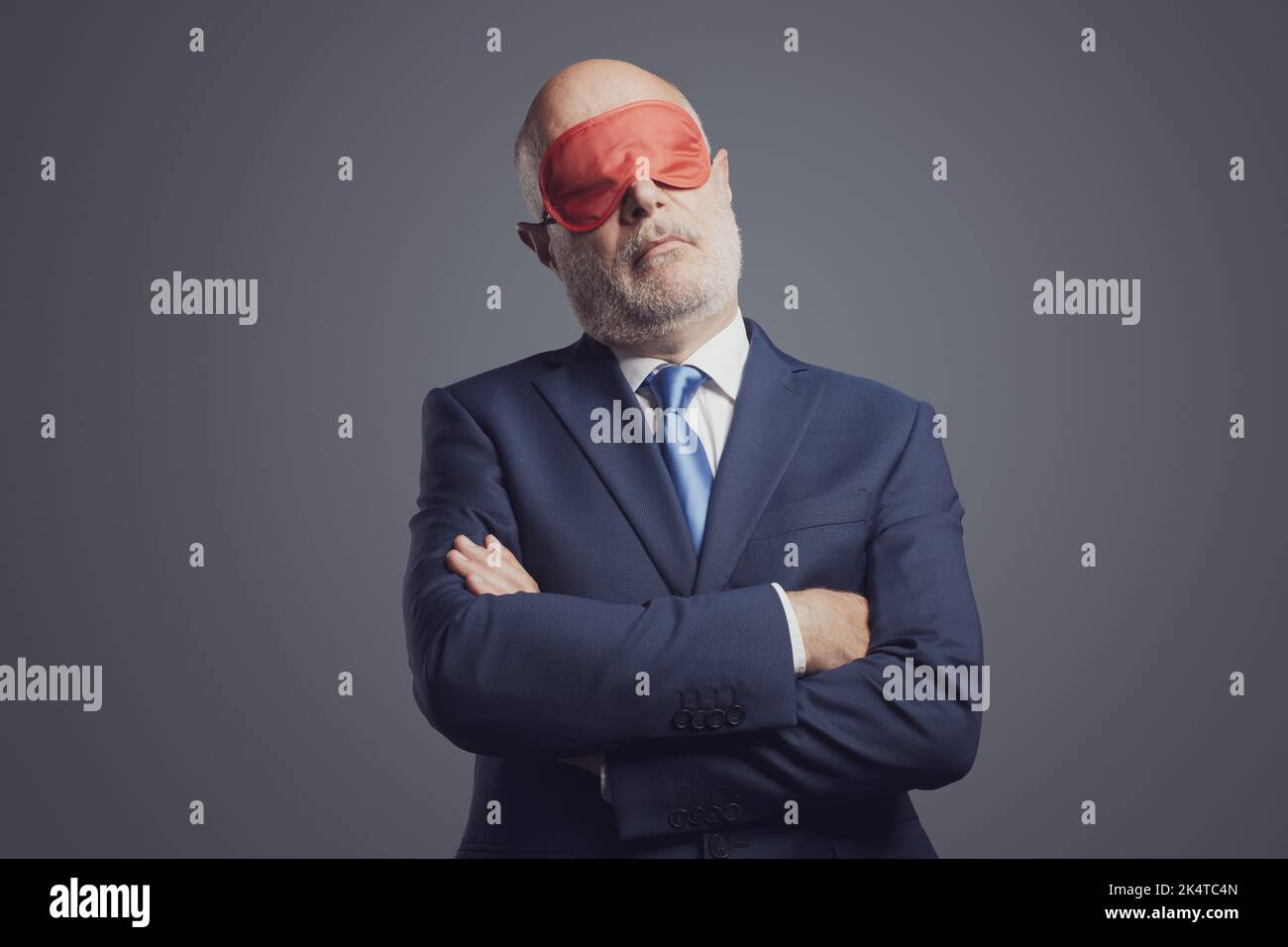 Sleepy careless businessman sleeping and wearing a sleep mask over his