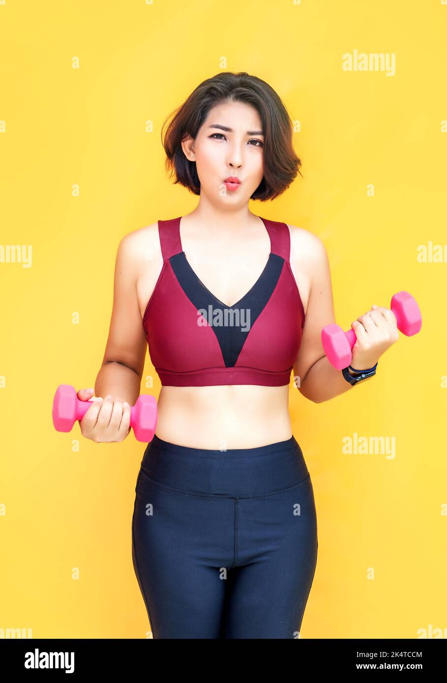 asian woman work out with dumbbel for wellbeing on isolated background Stock Photo