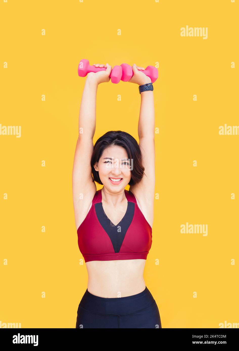 asian woman work out with dumbbel for wellbeing on isolated background Stock Photo