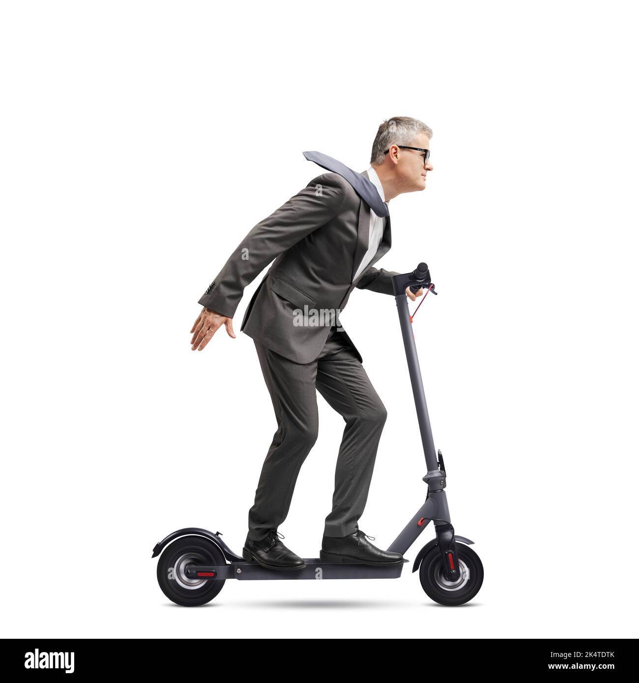 Corporate businessman riding a fast ecofriendly electric scooter