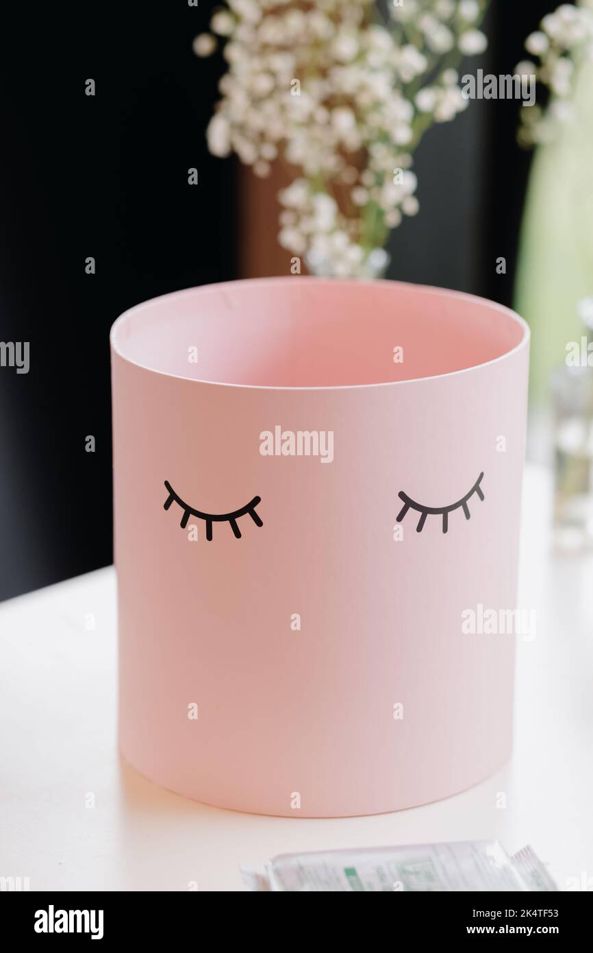Pink round gift box on white table Stock Photo