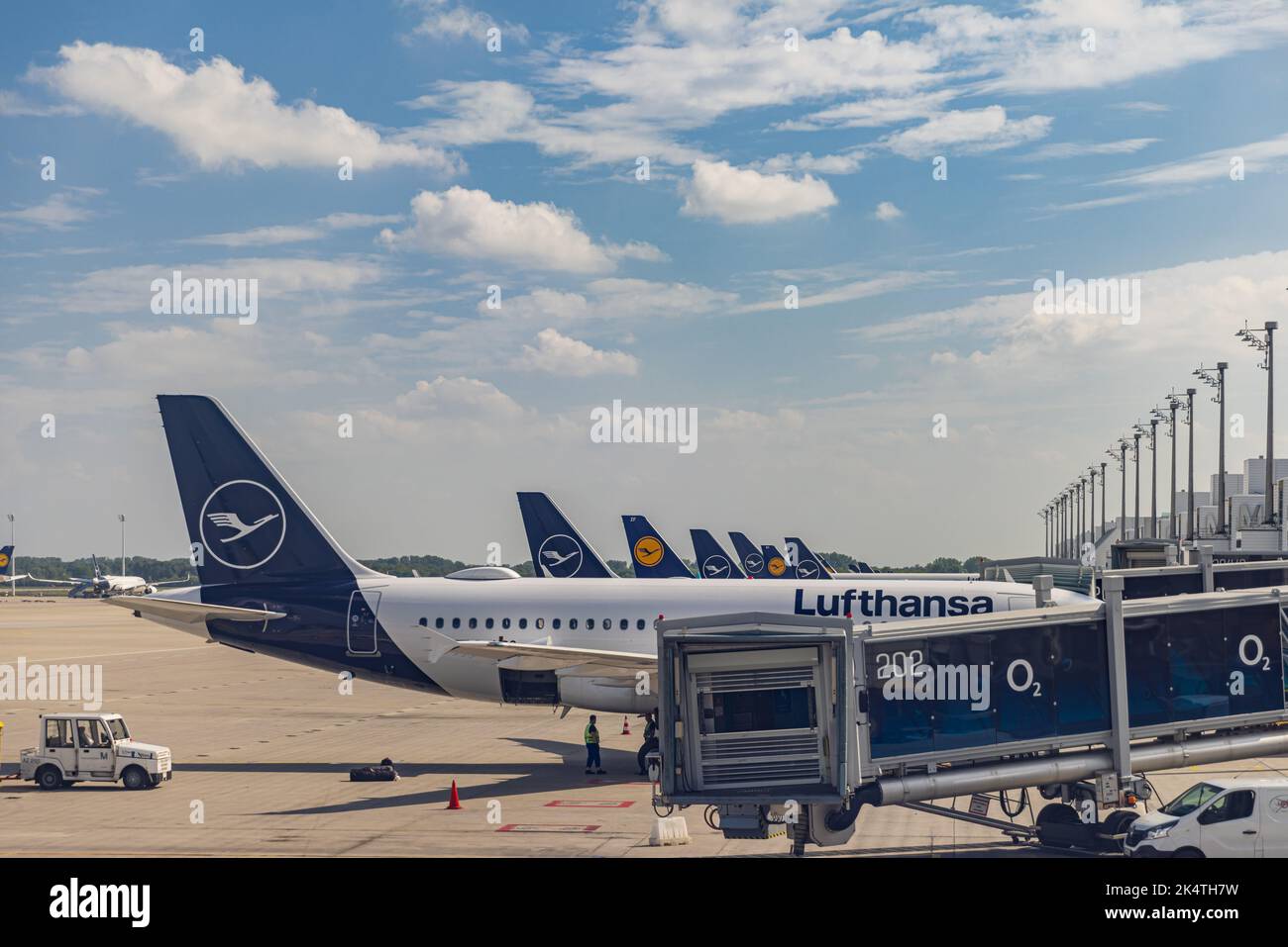 MUNICH, GERMANY - AUGUST 28, 2022: Lufthansa aircraft lined up at gates at Munich airport, an important hub for the airline. Stock Photo