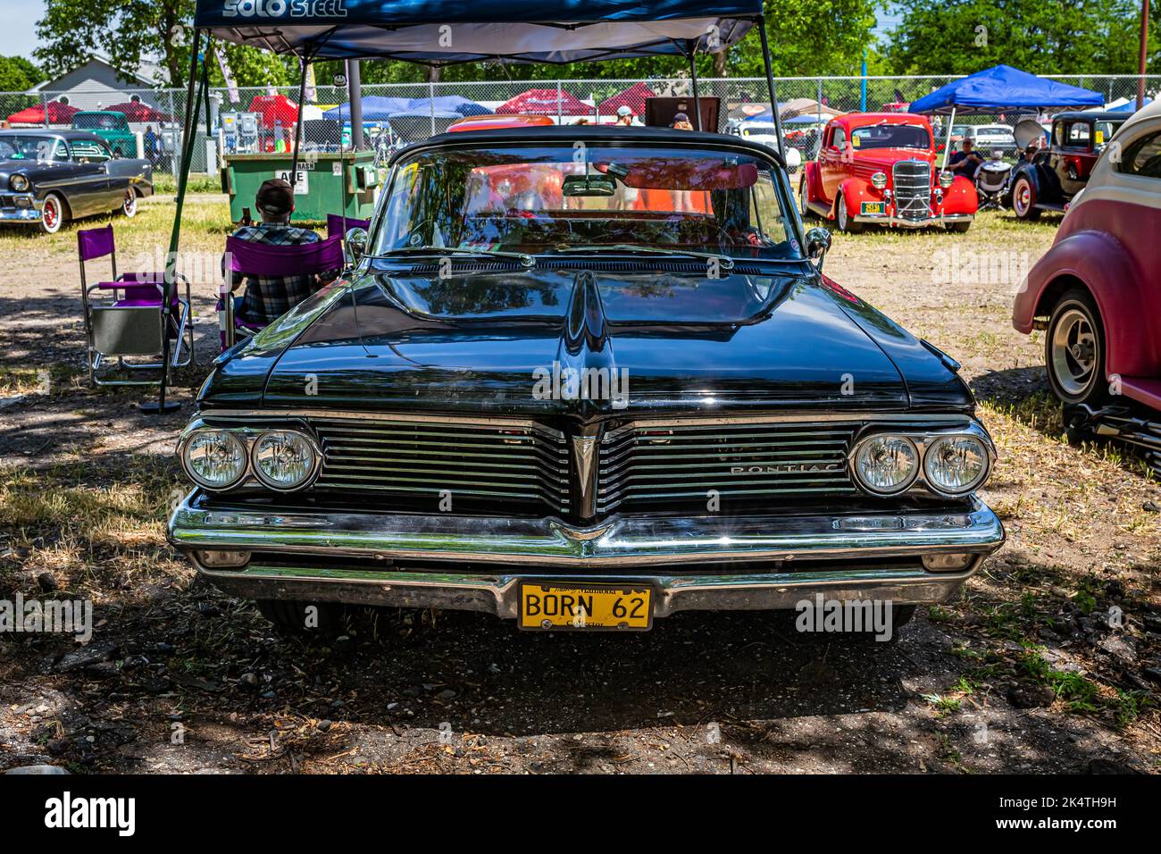 Falcon Heights, MN - June 18, 2022: High perspective front view of a 1962 Pontiac Parisienne Convertible at a local car show. Stock Photo