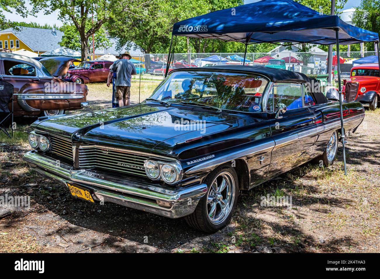 Falcon Heights, MN - June 18, 2022: High perspective front corner view of a 1962 Pontiac Parisienne Convertible at a local car show. Stock Photo