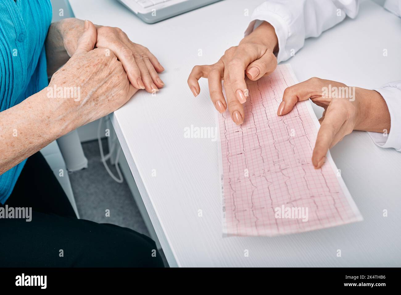 doctor cardiologist consulting woman patient on results of her cardiogram and heart test. Diagnostic heart diseases, cardiology Stock Photo